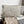 Load image into Gallery viewer, Floral-patterned pillow on a sofa with a neutral background
