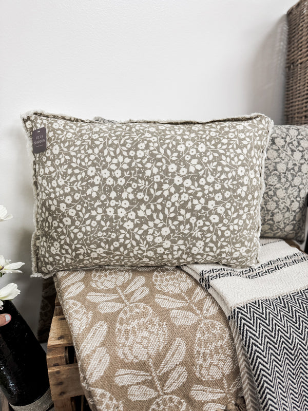 Floral-patterned pillow on a sofa with a neutral background